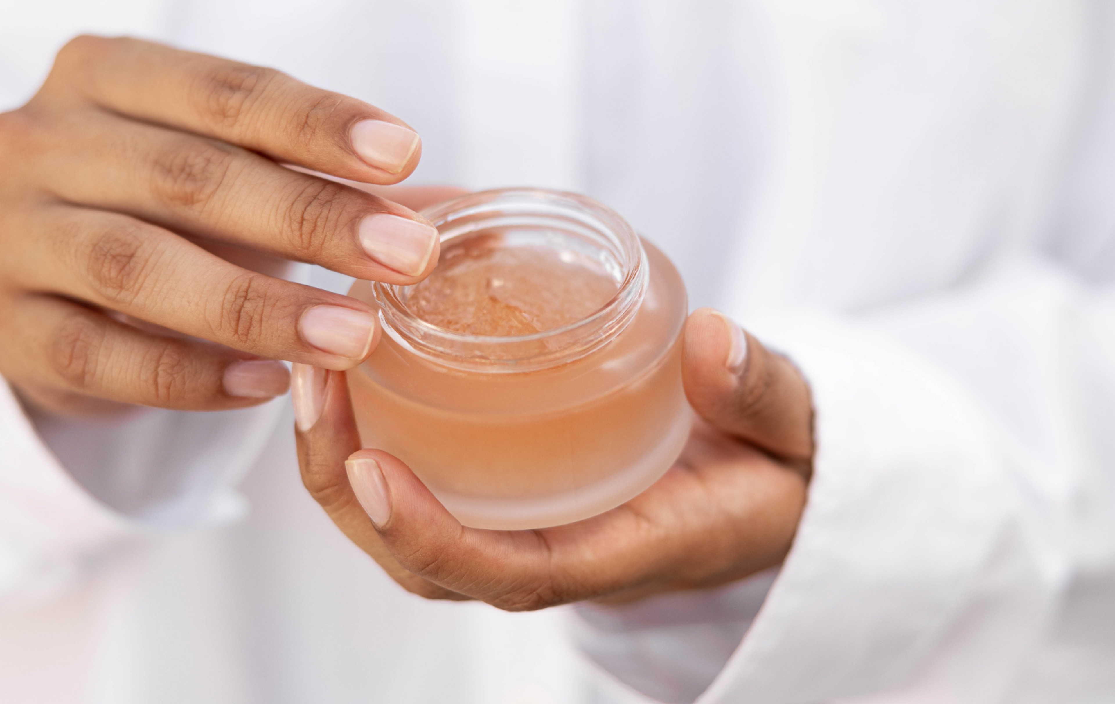 woman holding jar of gel like beauty product